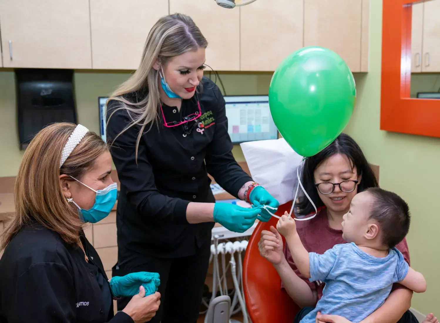 a group of people in a room with balloons