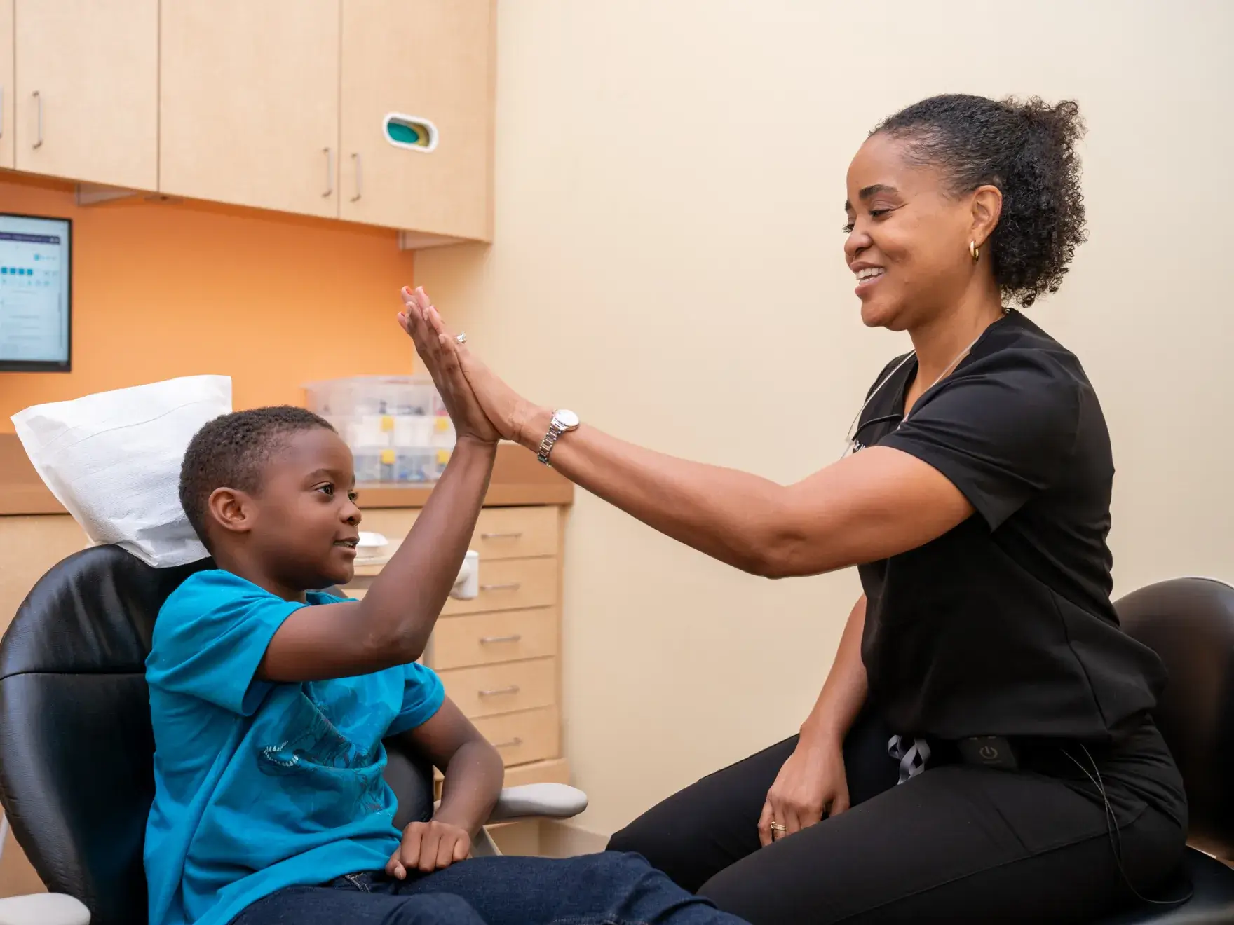 a woman giving a boy a high five