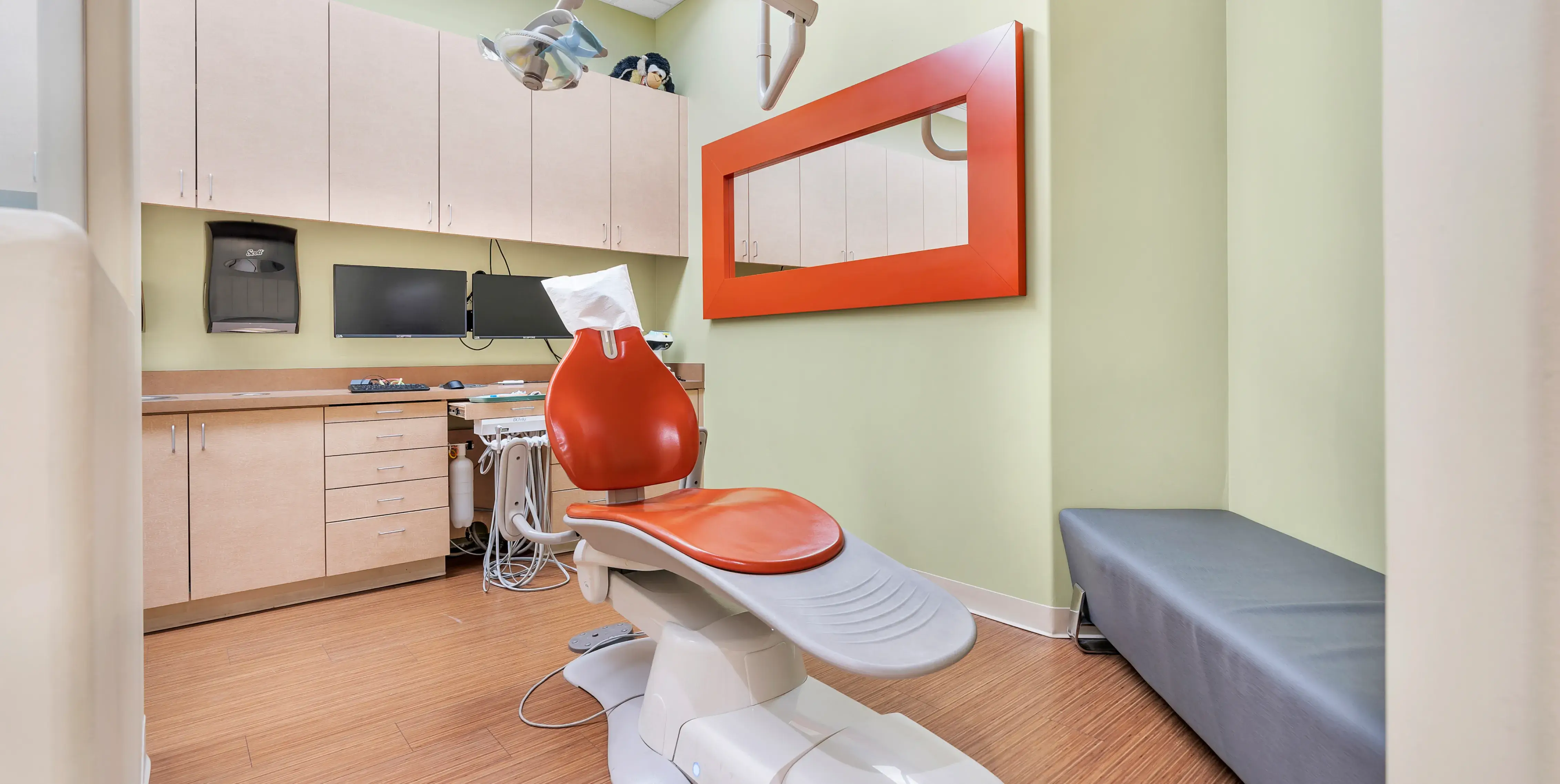 a dentist's office with a red and white chair