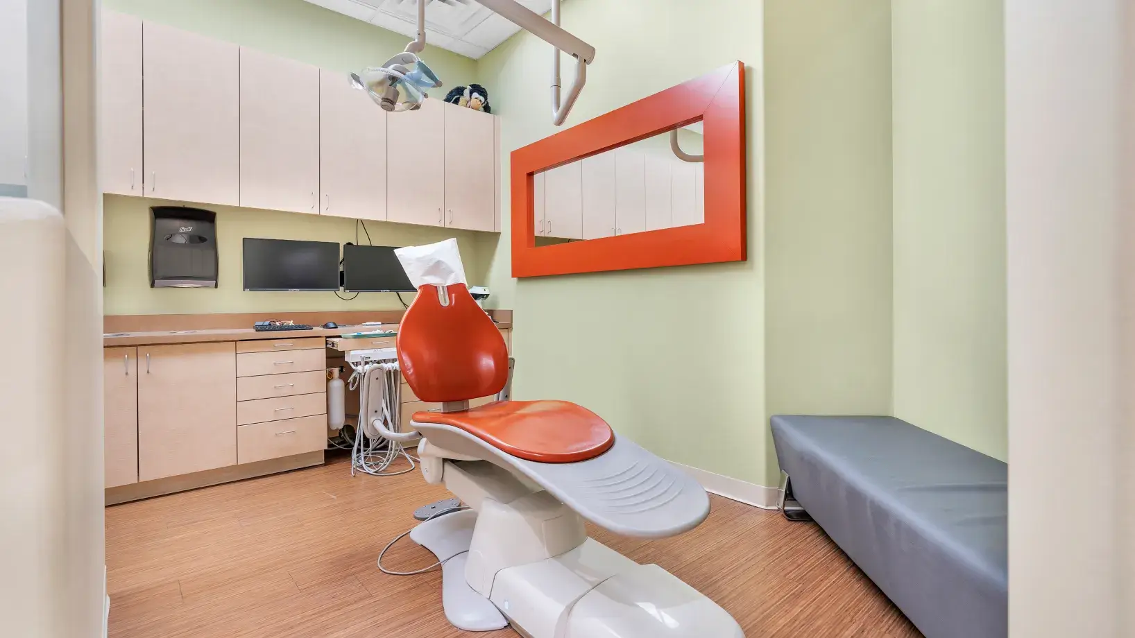 a dentist's office with a red and white chair