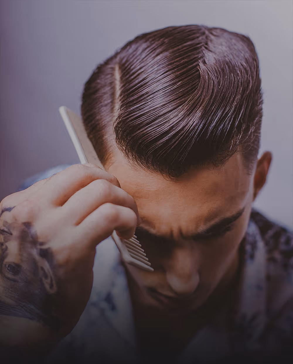 Classic men's haircut with side part and comb styling at The Chair Barbershop in Chicago