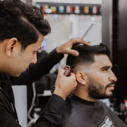 Detailed blade fade haircut with edge work by professional barbers at The Chair Barbershop in Chicago