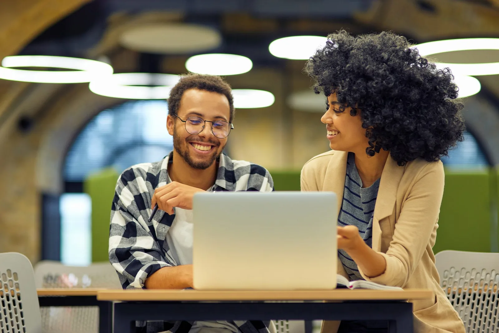 Business professionals collaborating on Microsoft technology on a laptop