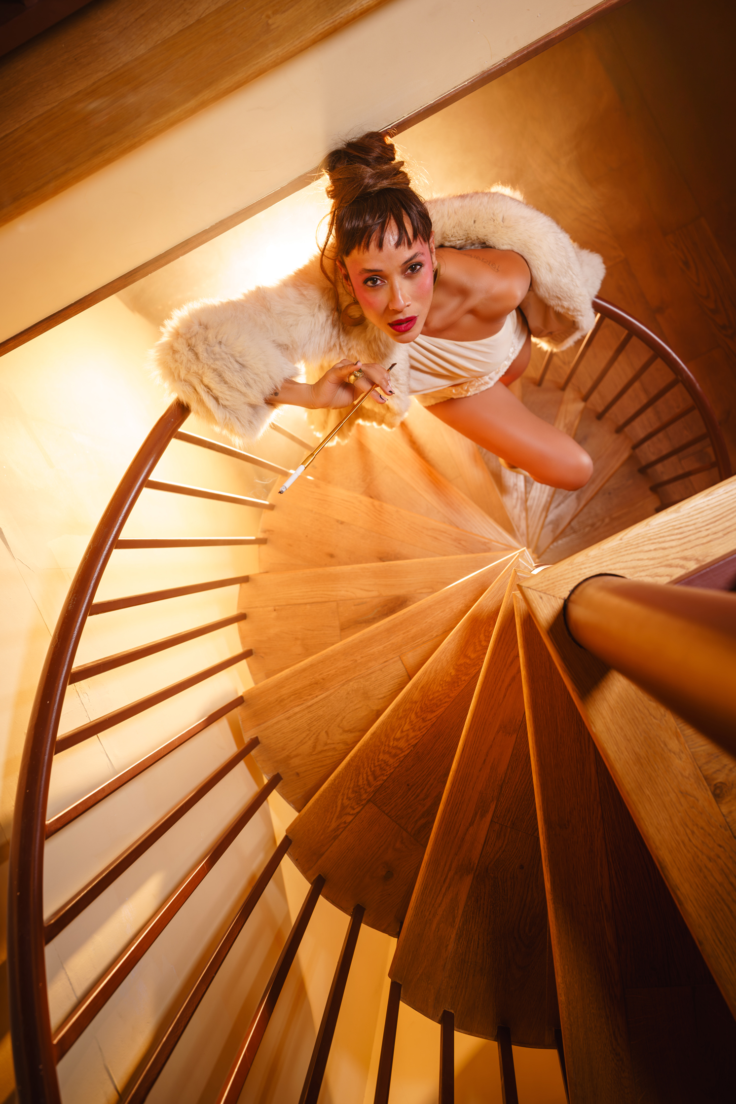 Dania Ramirez photographed on spiral staircase in cinematic overhead composition