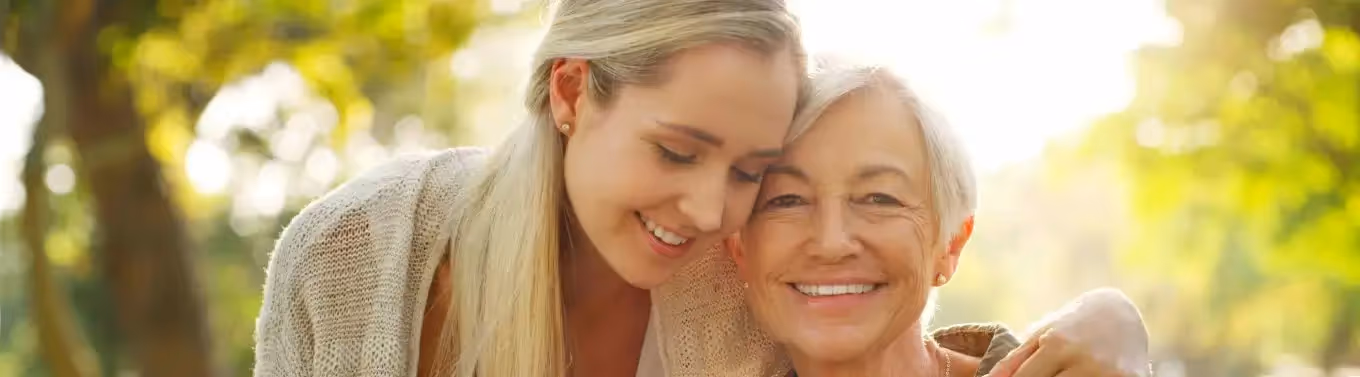 A daughter hugging her mother with dementia