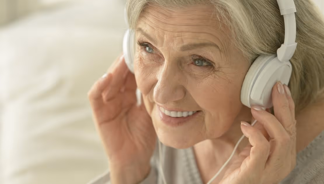 A dementia patient enjoying music from her headphones