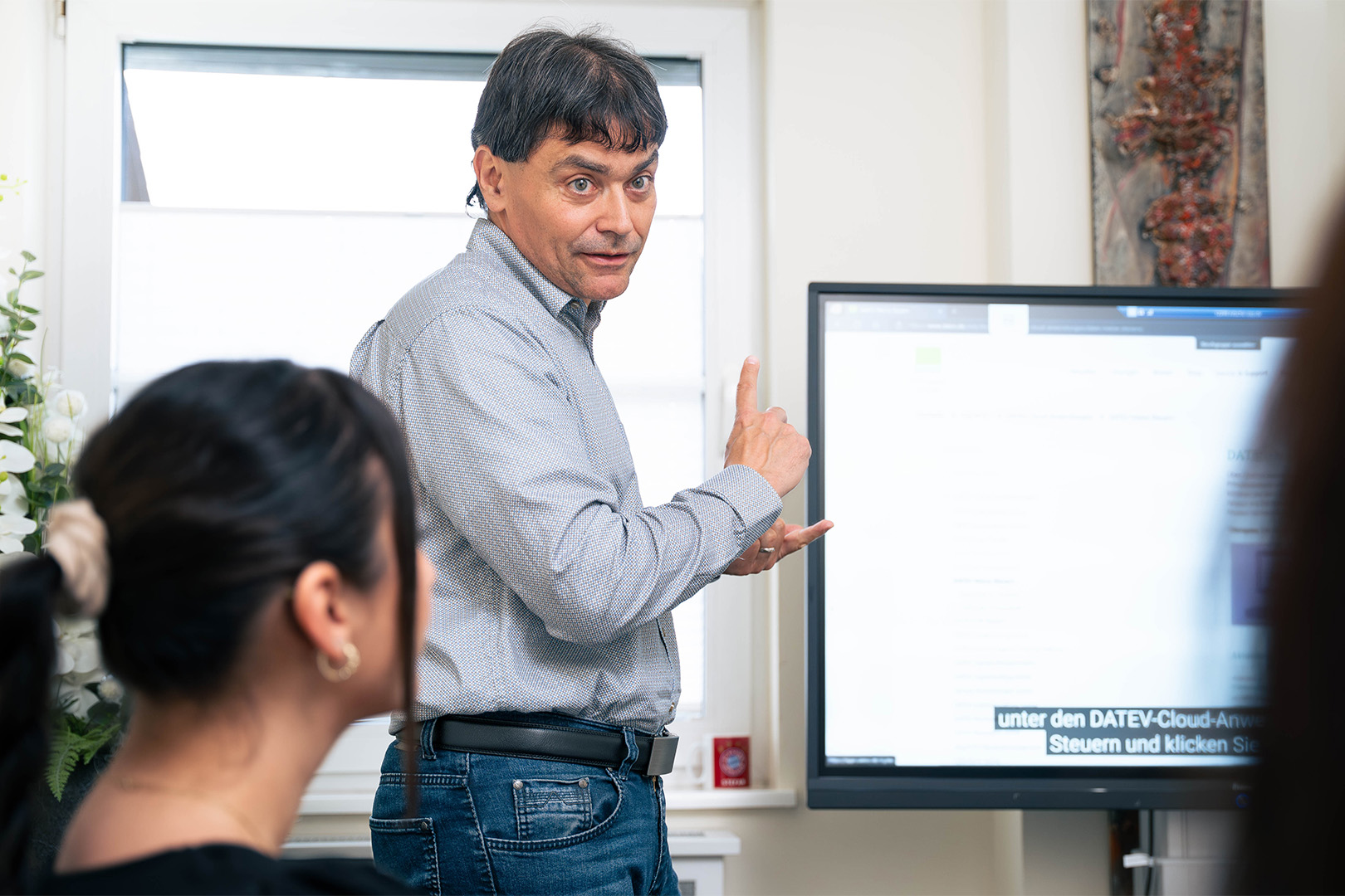 A contemporary house with a towering tree in the foreground.