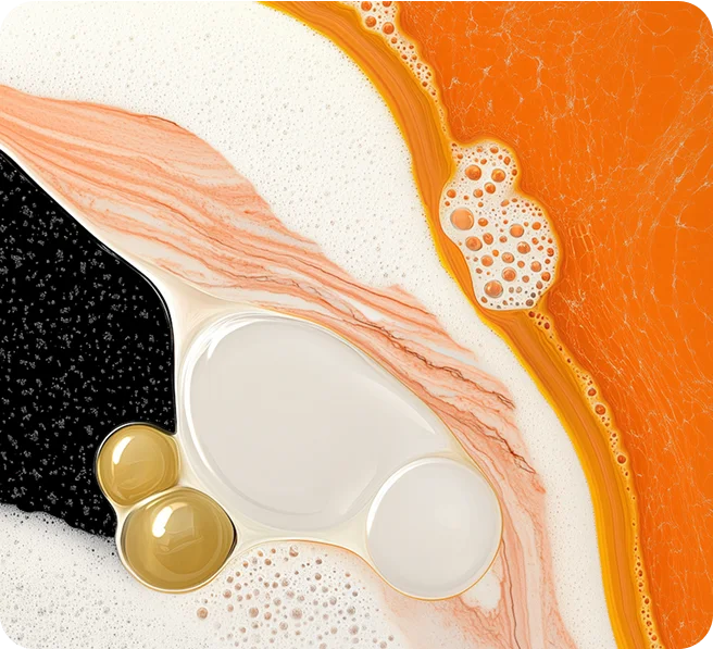 Abstract view of various colored liquid bubbles and foam in shades of orange, black, white, and beige.