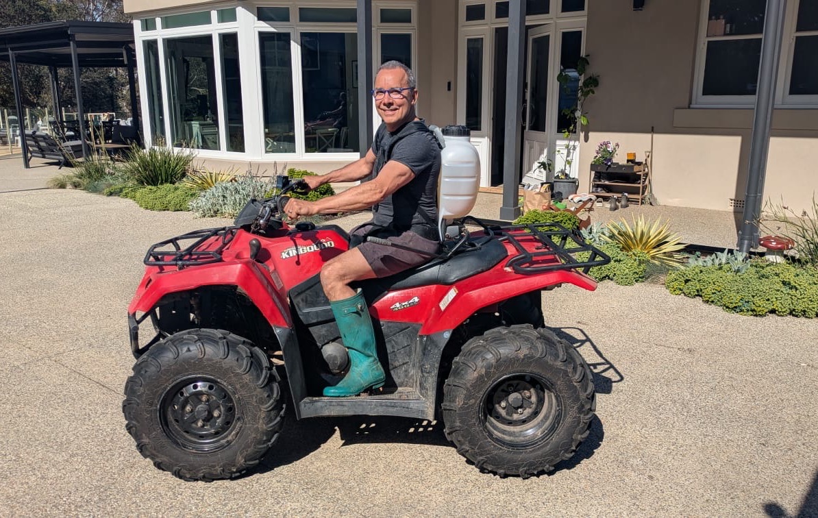 Dr Paul Spano on the quad bike at his property in the Macedon Ranges