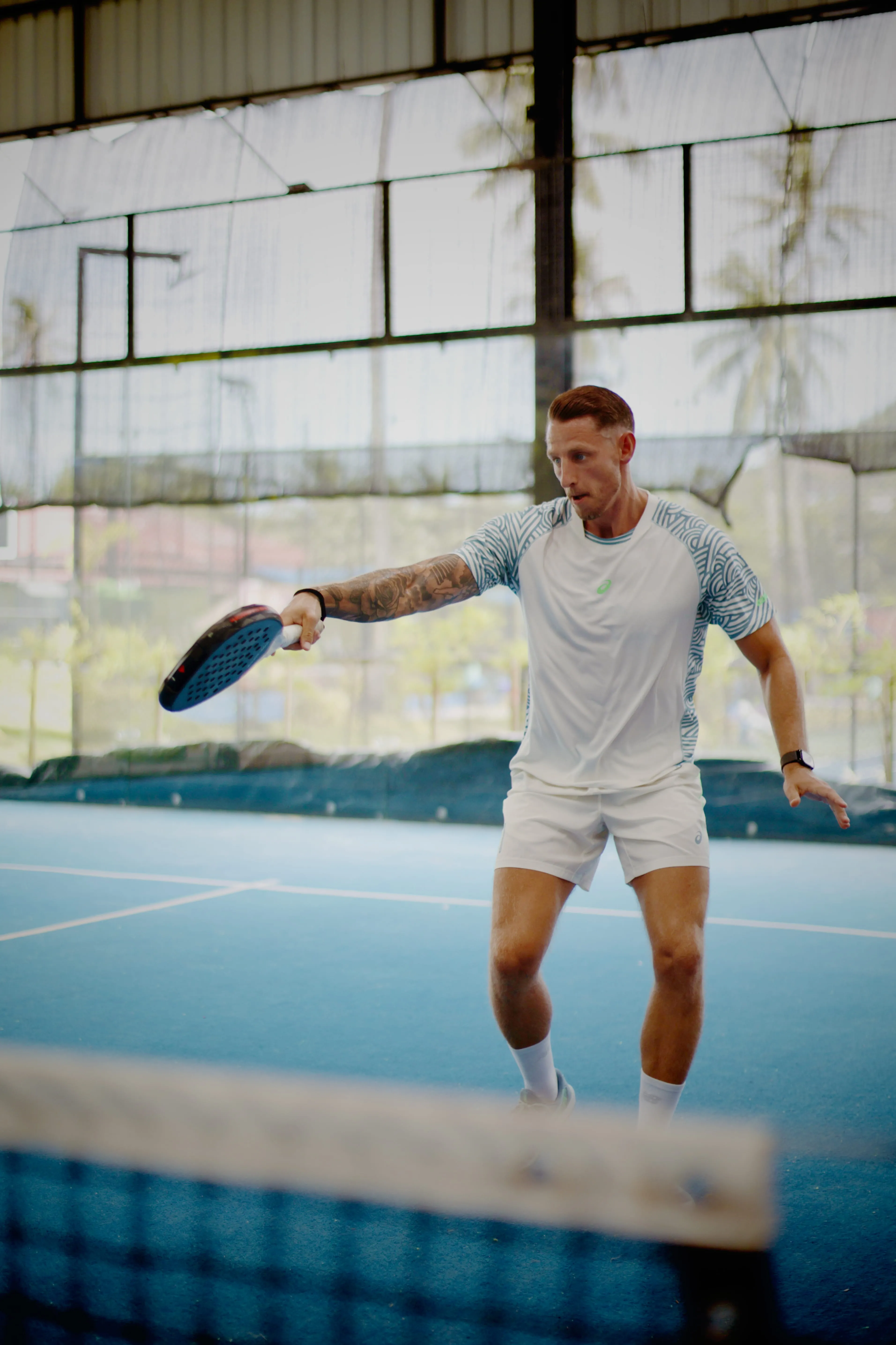 A Palaestra player volleying at the net in Koh Samui