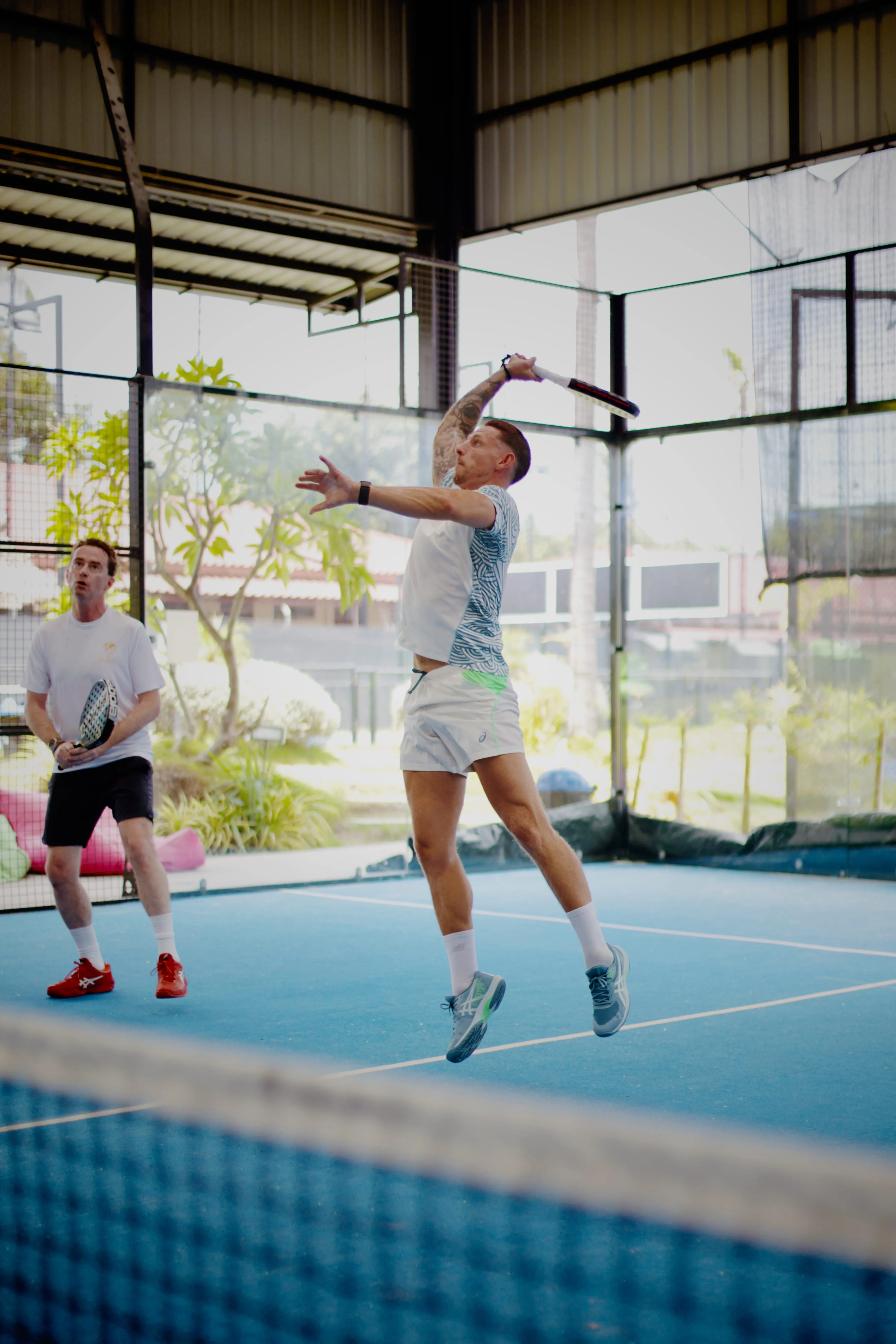 A Palaestra player mid-smash on court in Koh Samui
