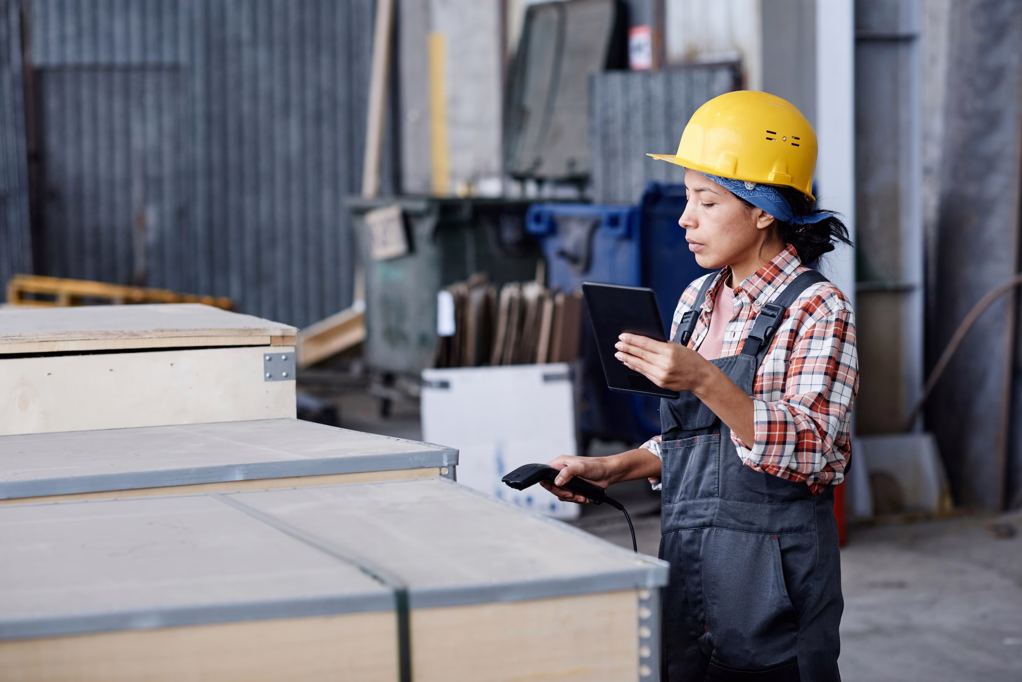 Ingenieur mit Helm kontrolliert Produktionshalle
