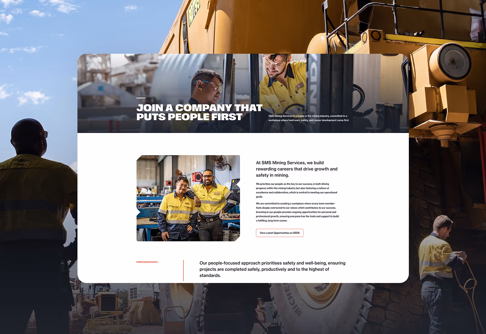 SMS Mining Services employees in high-visibility uniforms working together inside a mining facility.