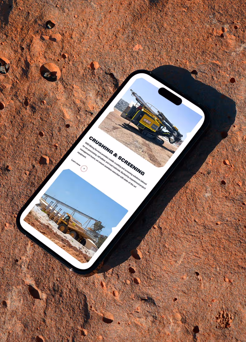 Smartphone screen showing SMS Mining Services’ crushing and screening equipment on a red dirt background.