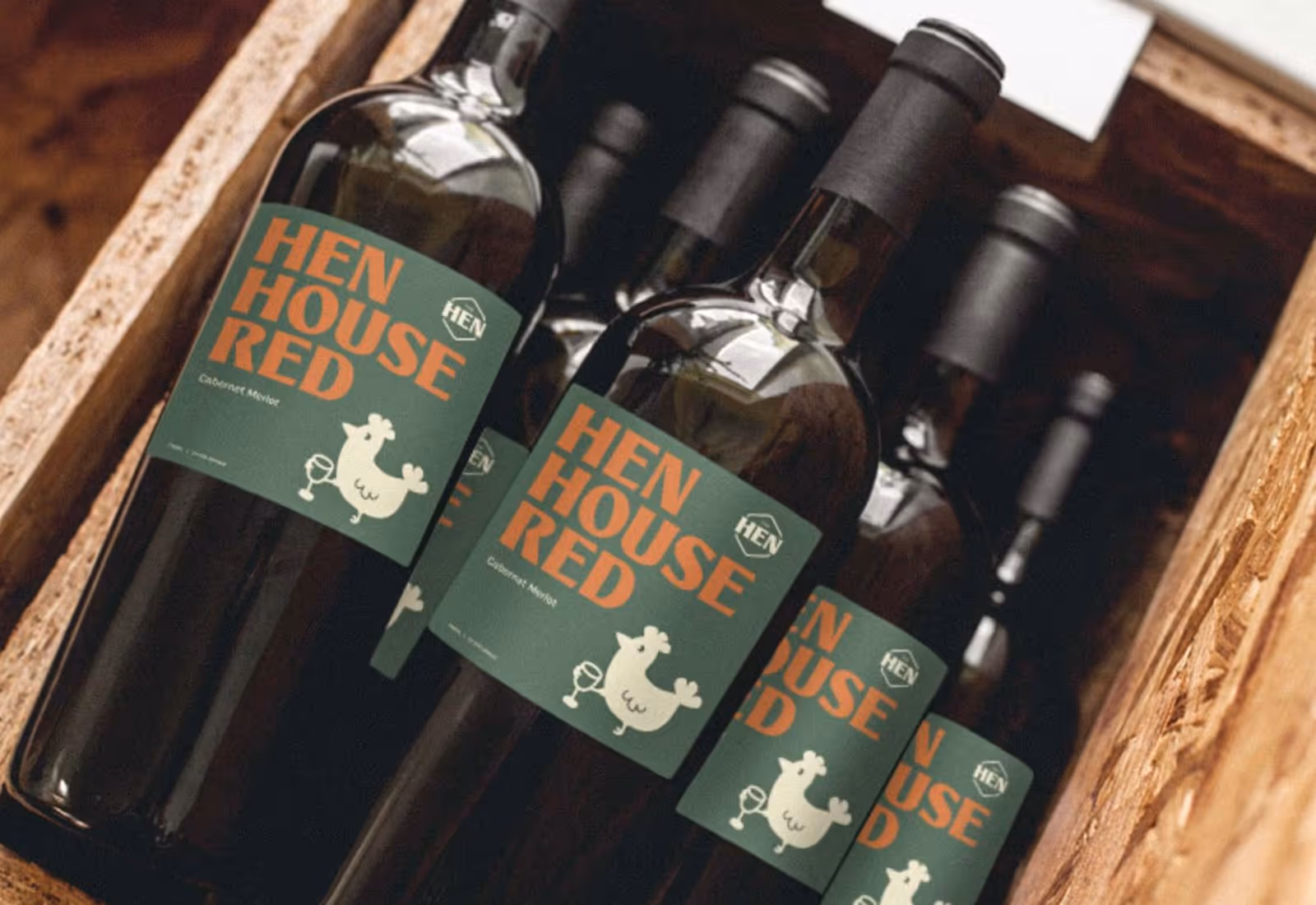 Bottles of Hen House Red wine neatly arranged in a rustic wooden crate