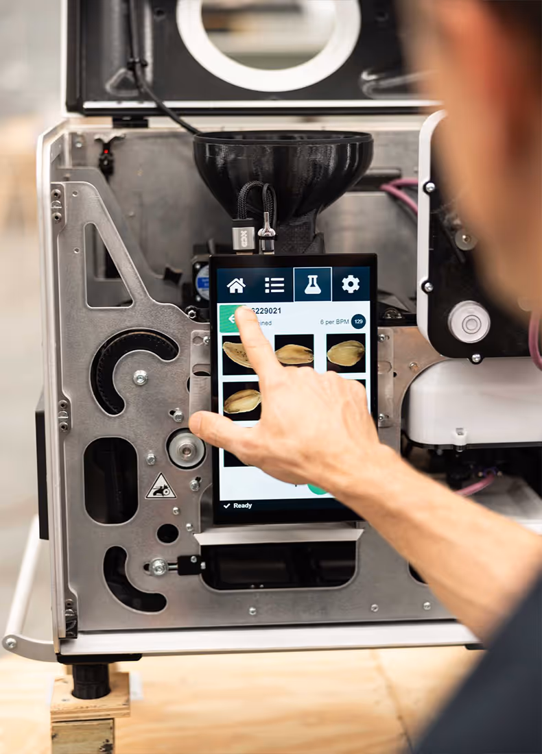 Close-up of touchscreen interface analysing grain samples on a Deimos machine