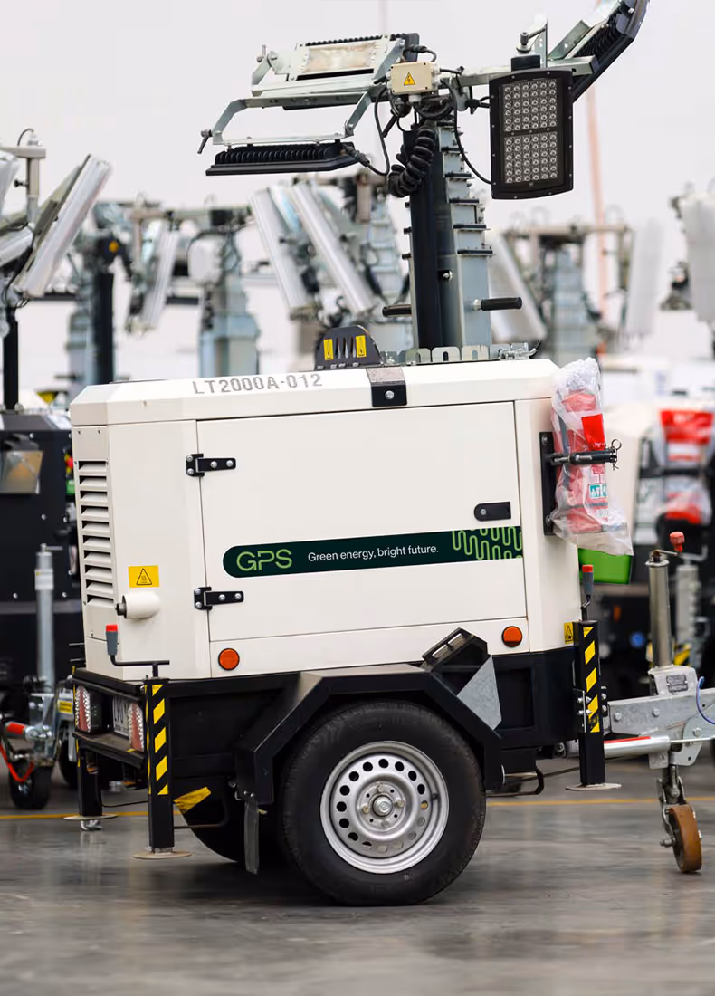 Close-up of a GPS-branded light tower unit among similar equipment in a warehouse