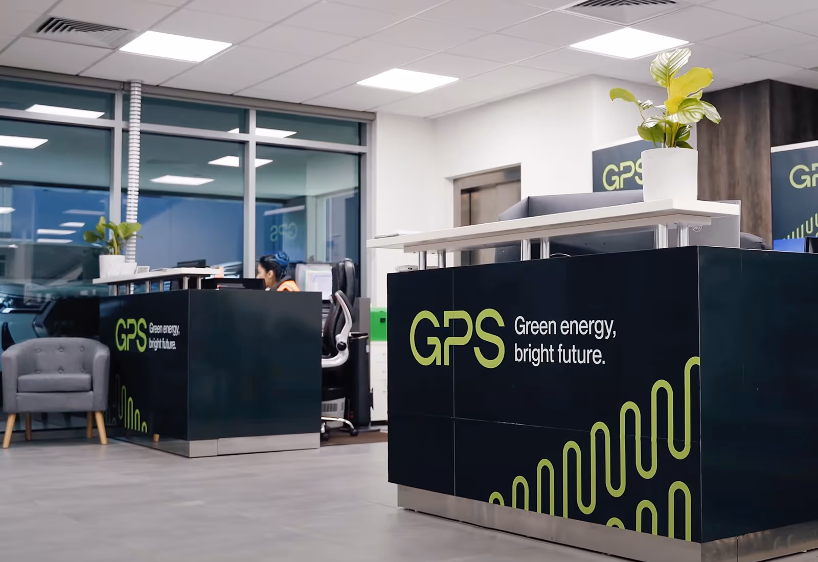GPS-branded reception counter with modern decor and green branding elements