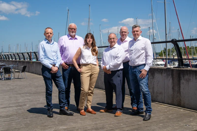 The BCi Digital Team standing in front of Gosport Marina, home to the HQ, in Hampshire, UK