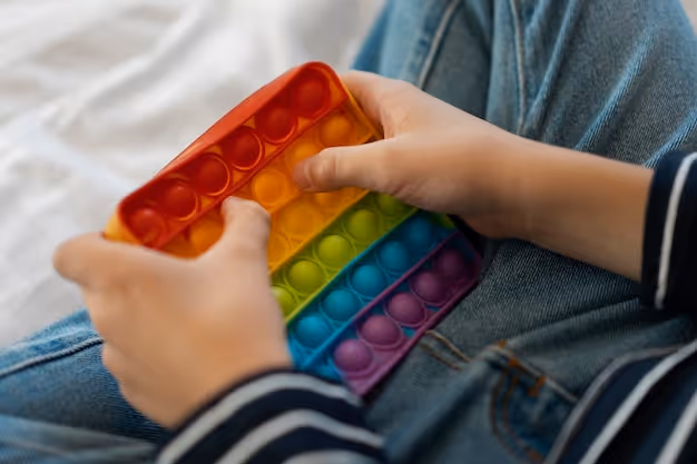 Close up on child playing with pop it toy
