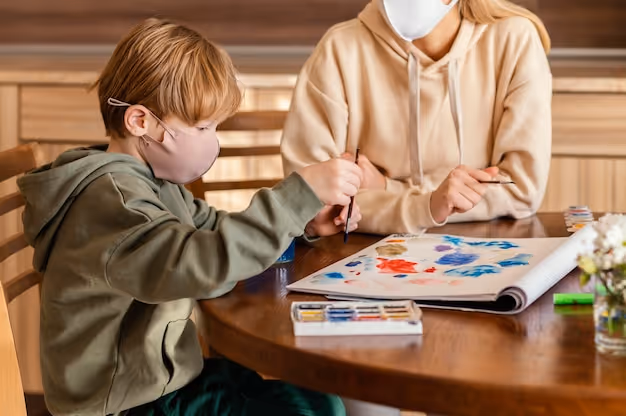Close-up kid painting on paper
