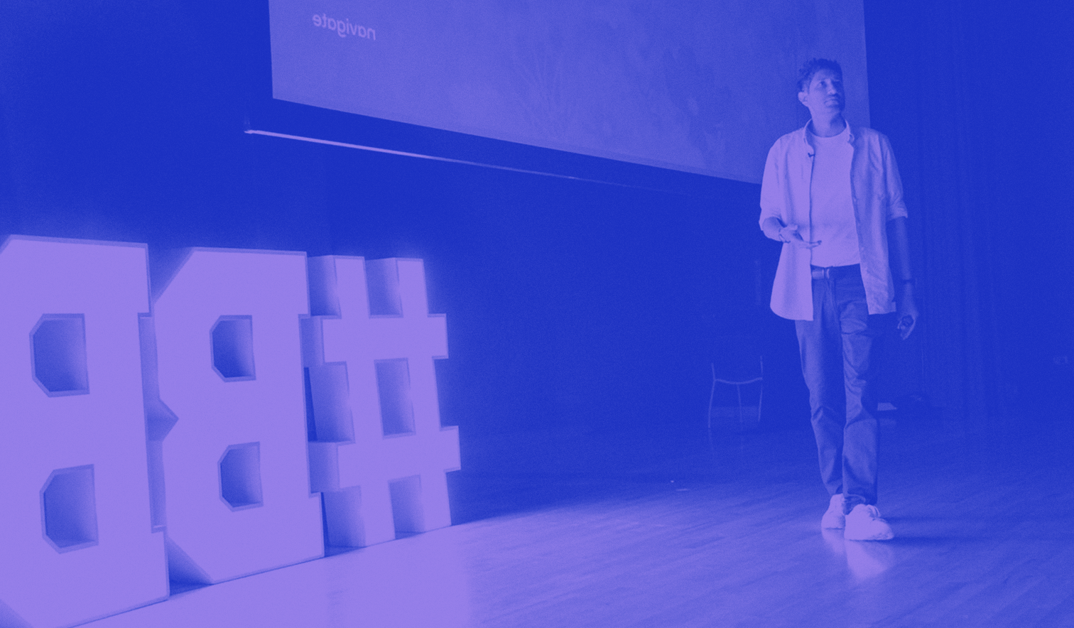 Man presenting at the front of a Building Brands conference