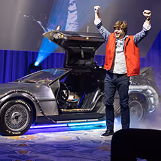 A sales executive exits a Back to the Future DeLorean.