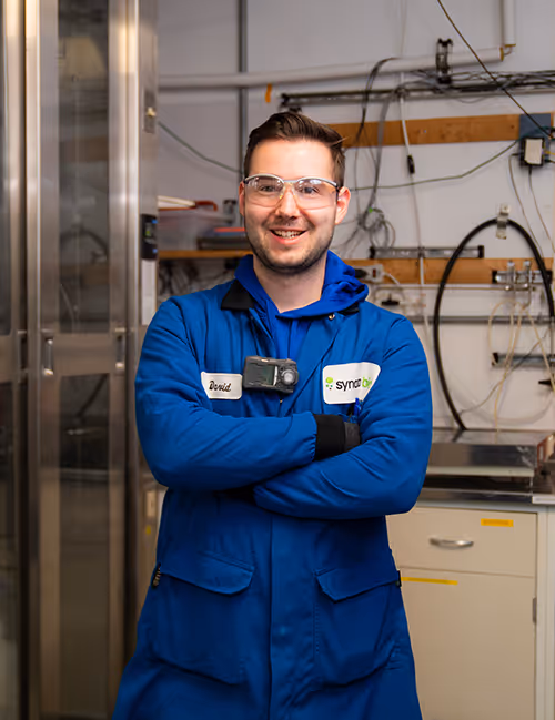 A lab scientist in a hero pose in a tech room for Synata Bio.
