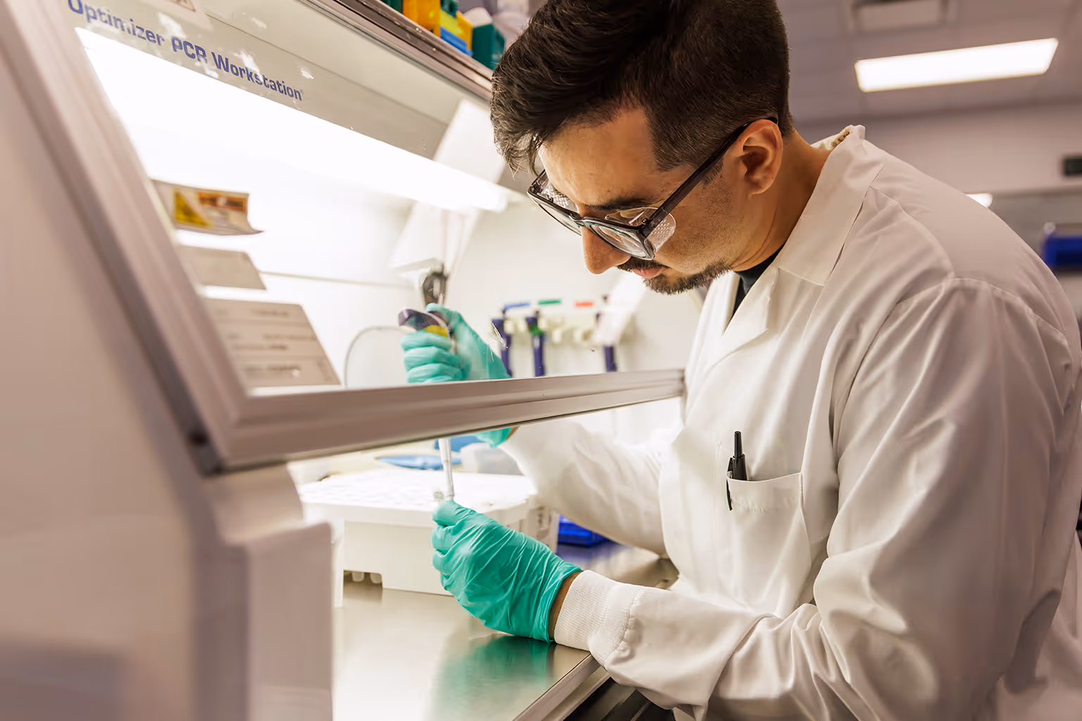 A technician at natera dropping samples in via pipette