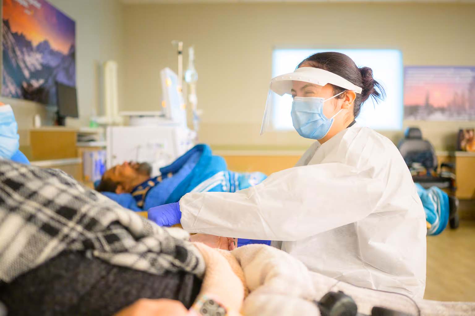 Patient Care Technician at DaVita helping a dialysis patient