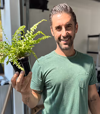 Jeff is holding a plant.