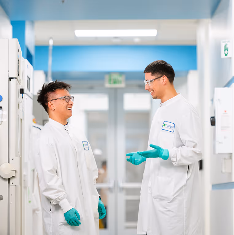 Two employees in the lab are laughing and living the Natera culture.