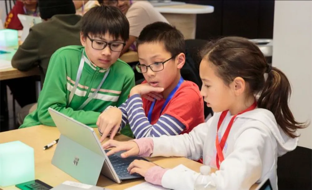 Three kids using a tablet device.