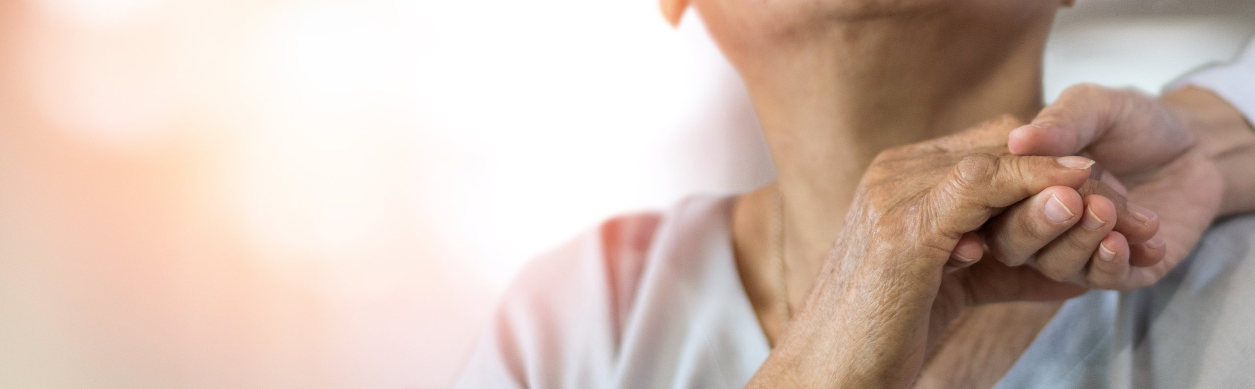banner image of person holding hands with aged care person