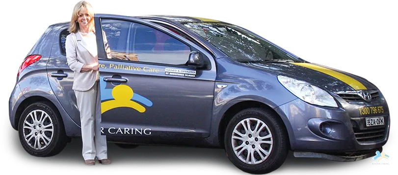 image of pam blake company founder of kinder caring standing next to the company car