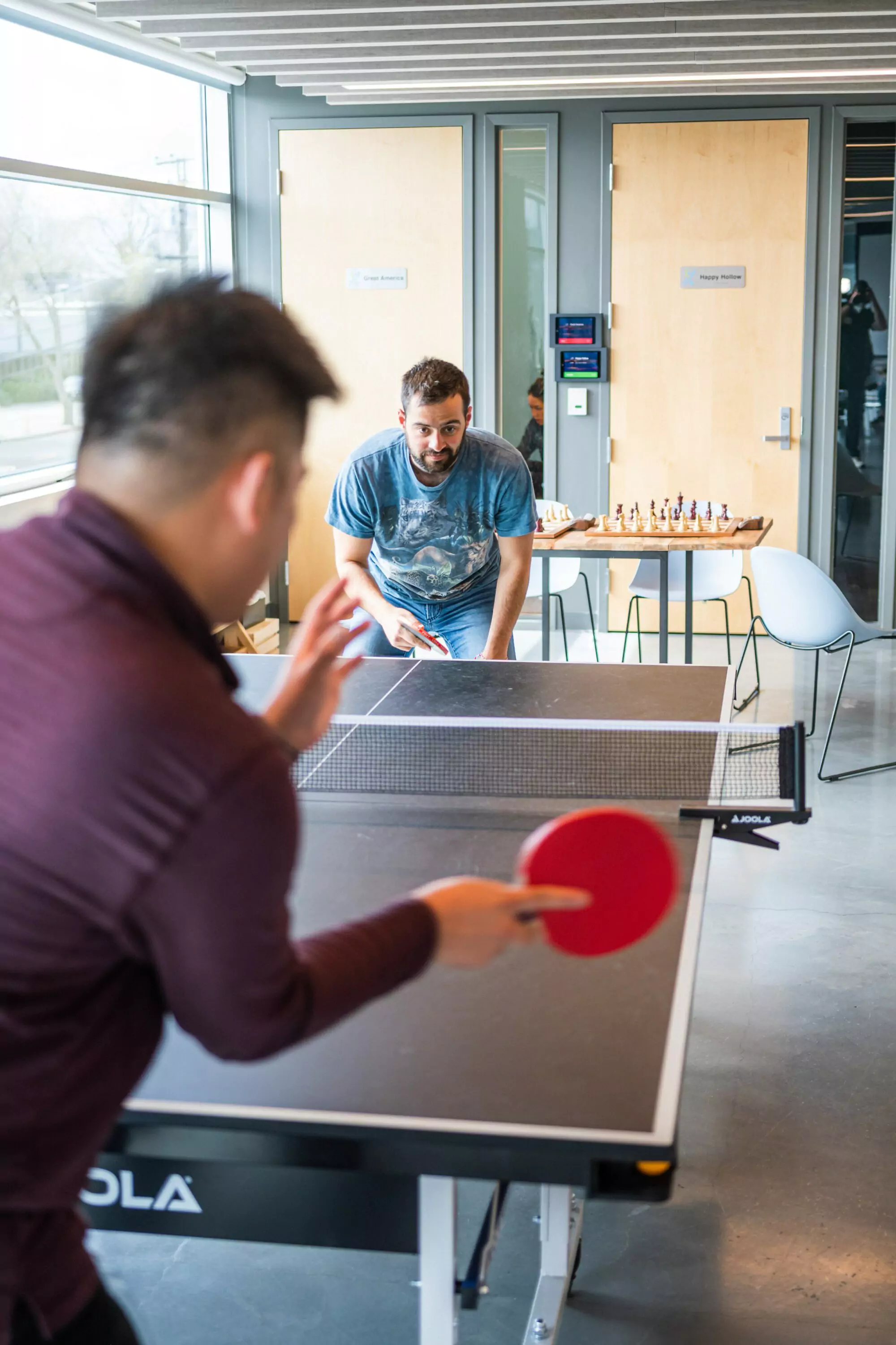 Two men playing ping pong