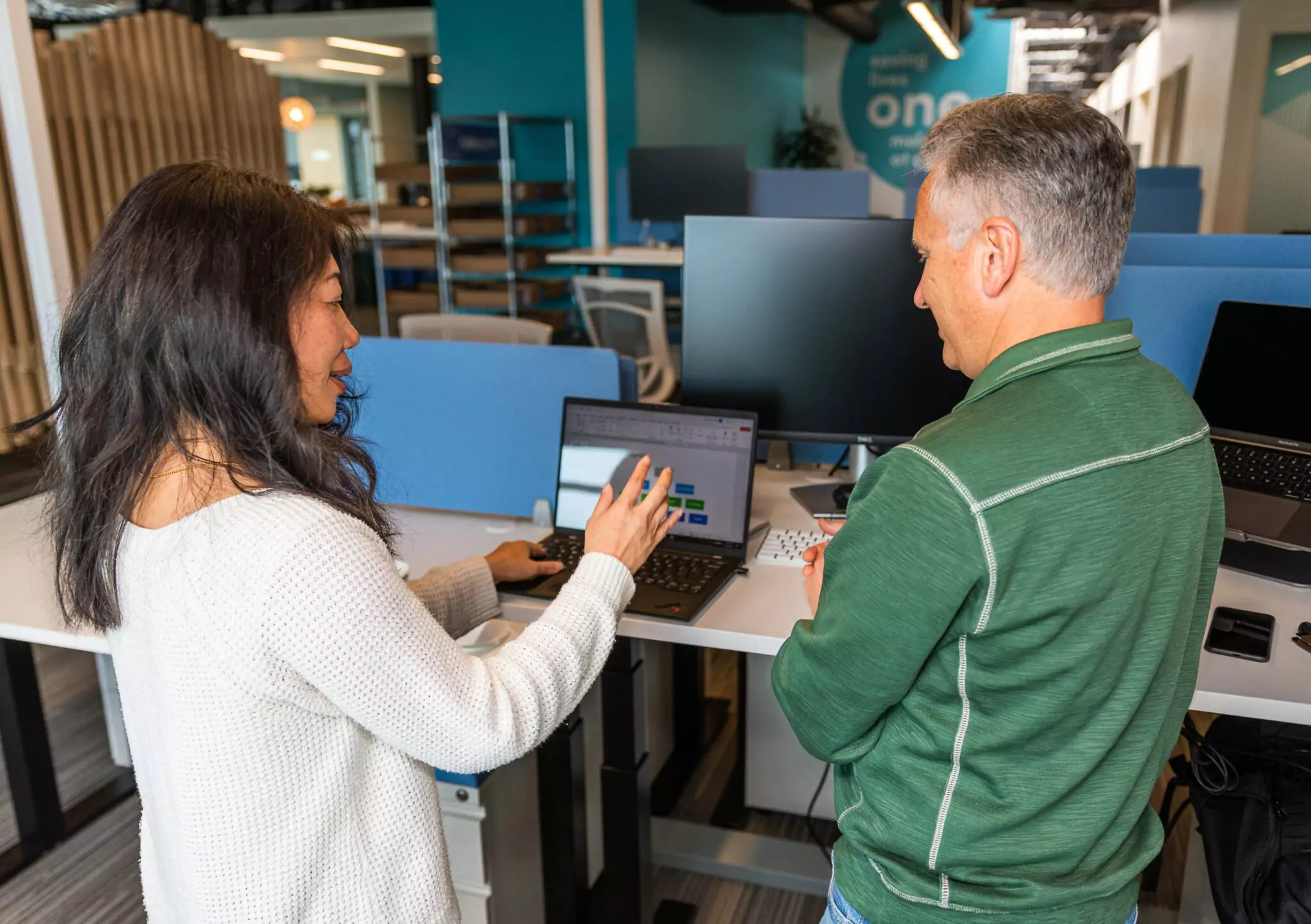 A woman and a man are having a conversation in the office
