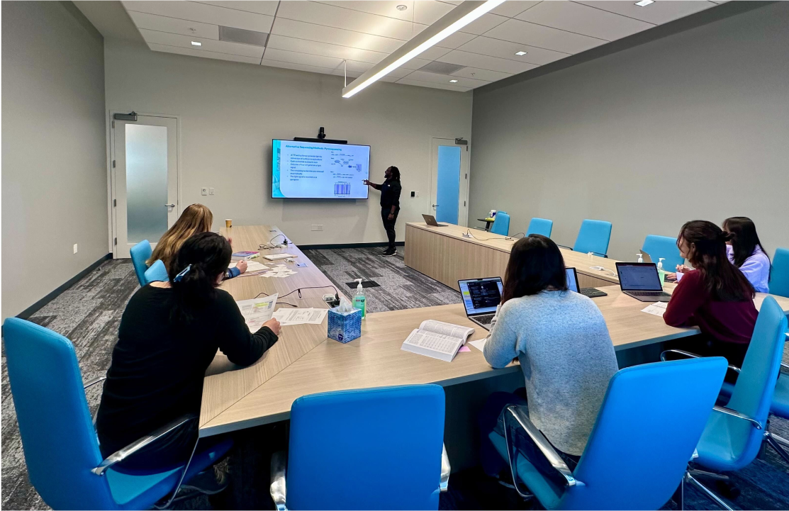 A group of people watching a presentation in the conference room