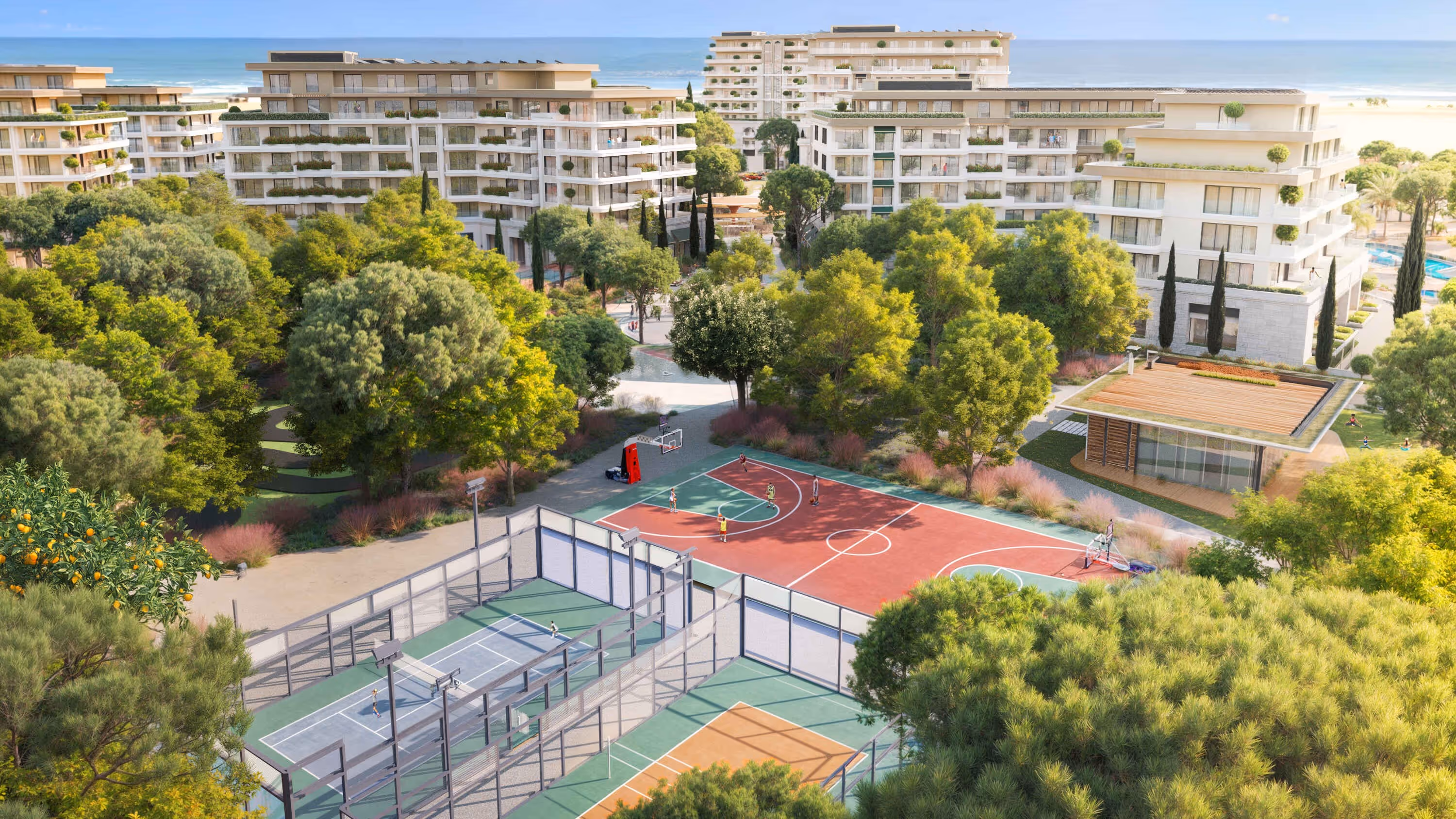 Basketball, tennis, and sports courts surrounded by lush greenery at Porta Rai residences.