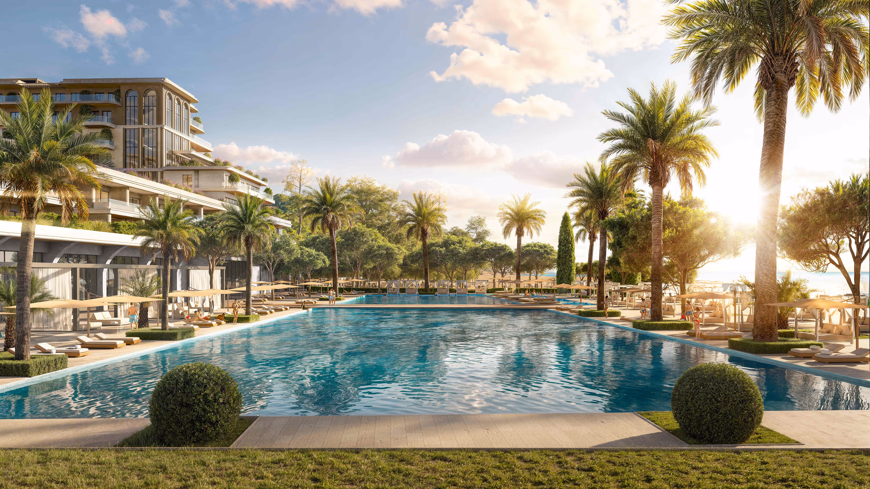 Large swimming pool at Porta Rai surrounded by palm trees, with sunset over the Adriatic Sea.