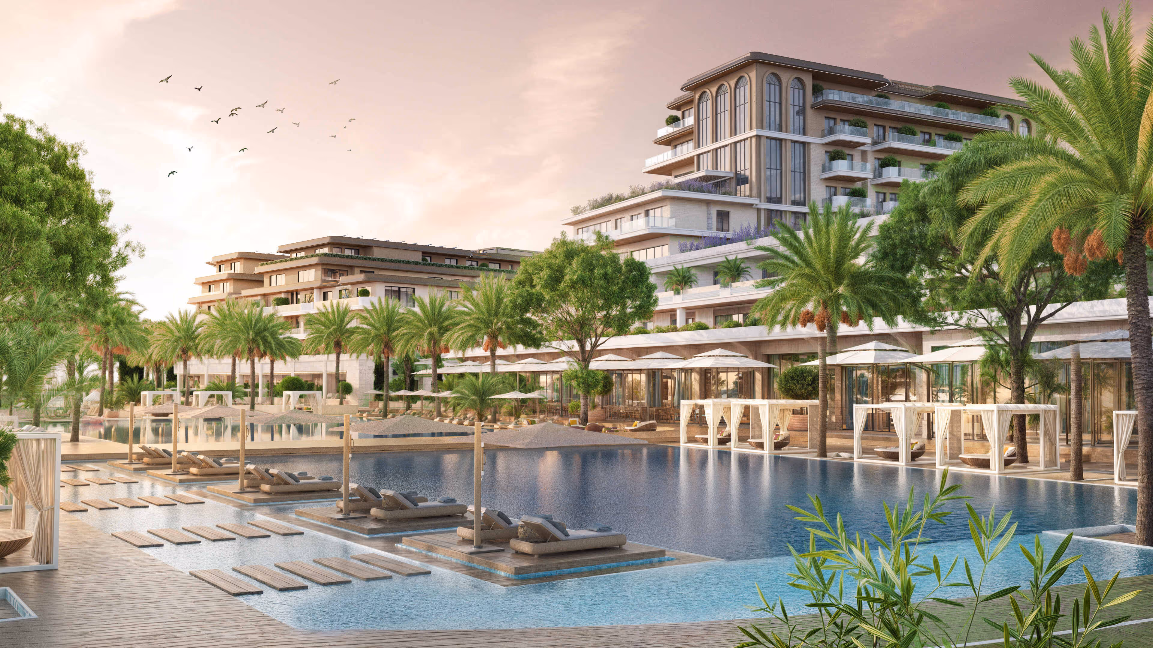 Luxurious poolside area at Porta Rai featuring palm trees, cabanas, and beachfront architecture.