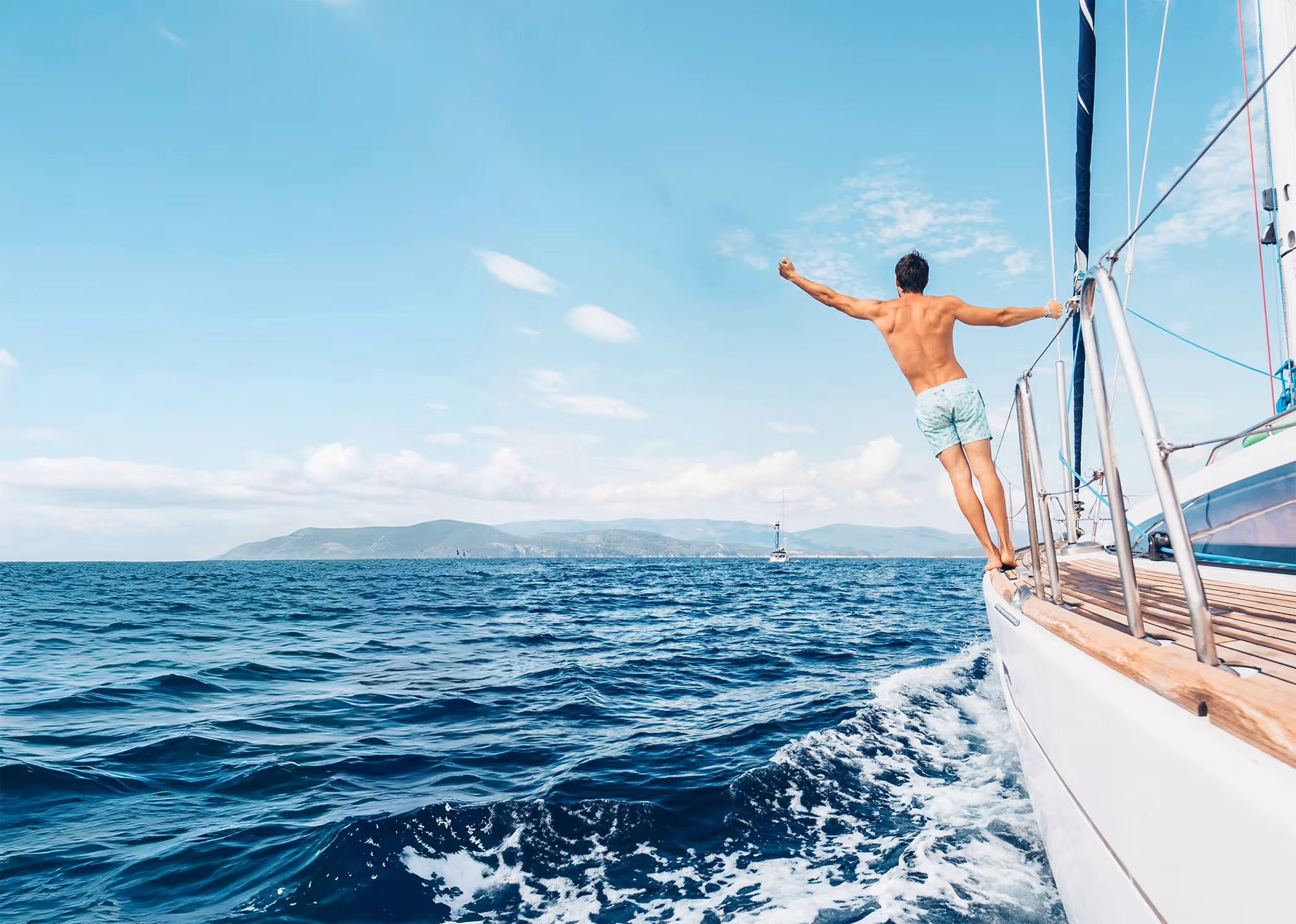 Man diving from sailing yacht in the Adriatic Sea