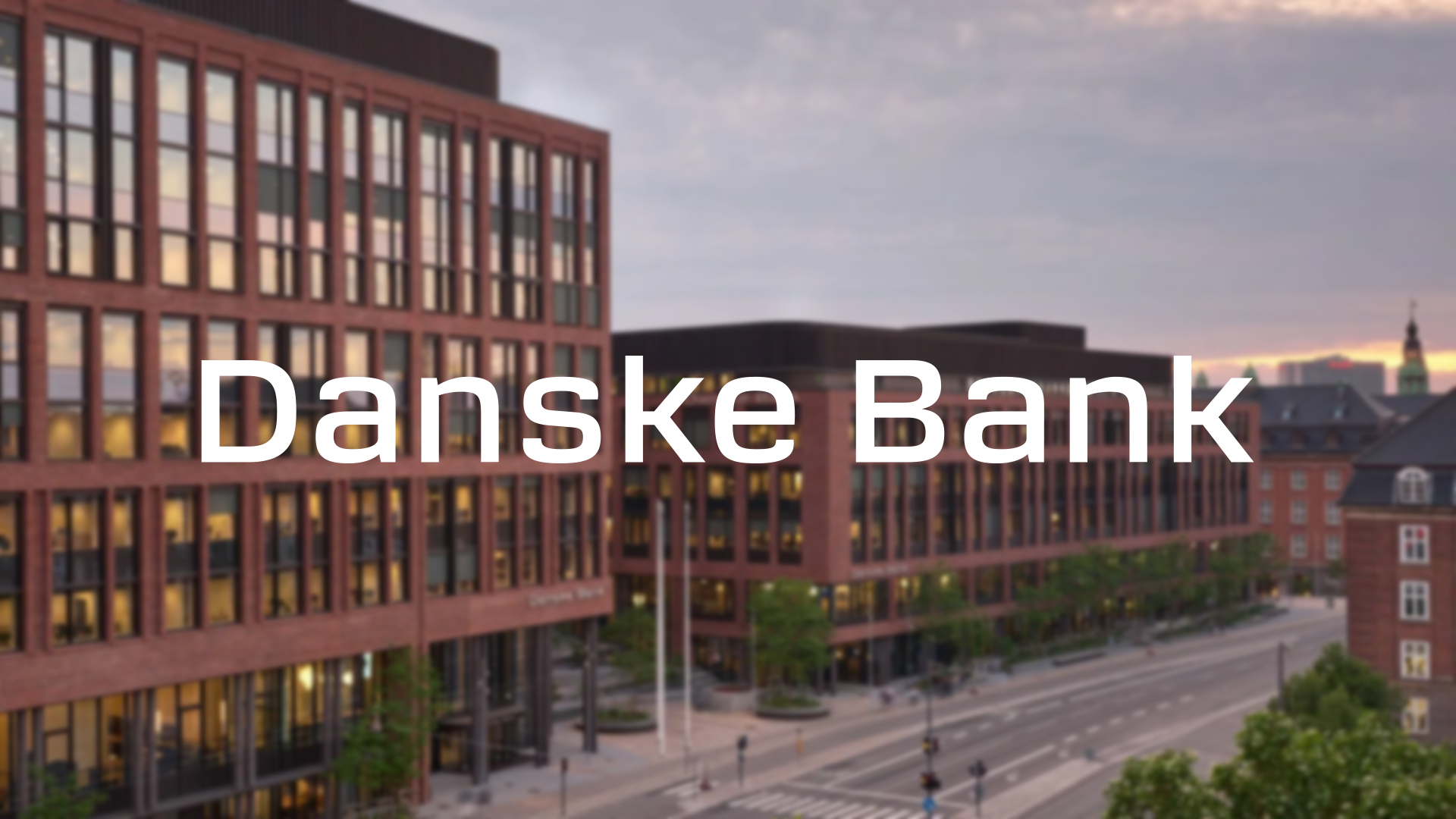 A photo of Danske Bank's logo in white on top of an image of their headquarters