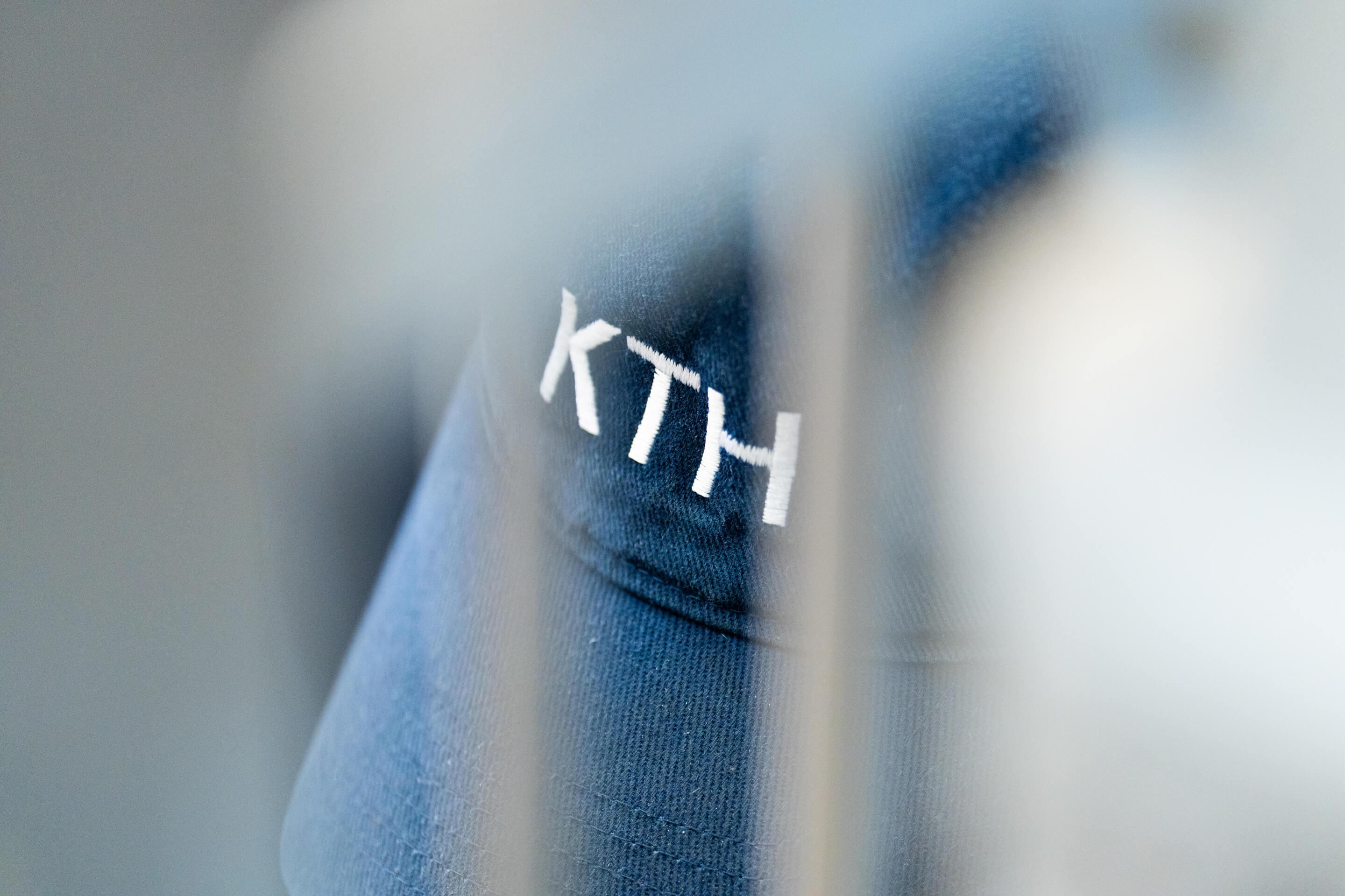 Close up shot of an employees company hat with the logo on front