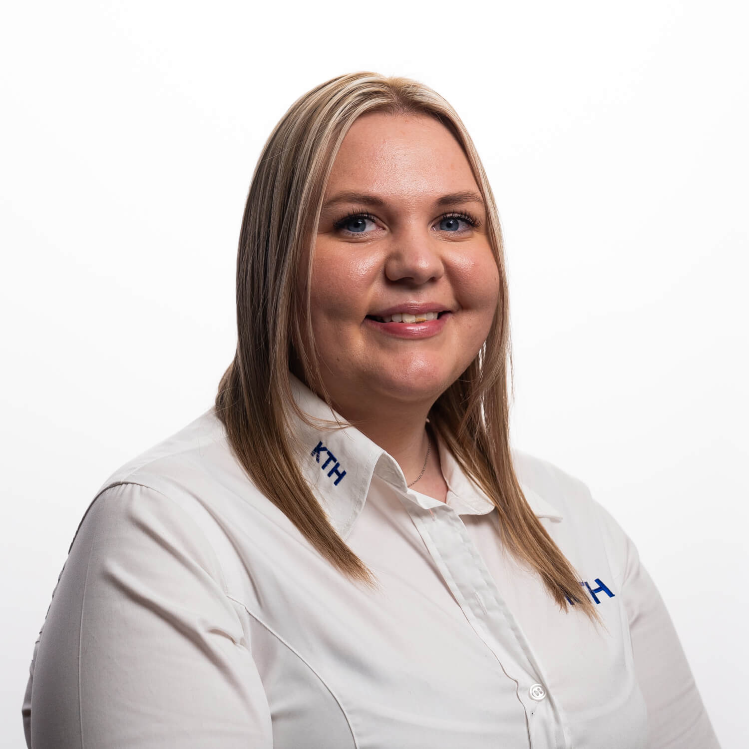 A portrait of Chloe Ellis on a white background in their work uniform