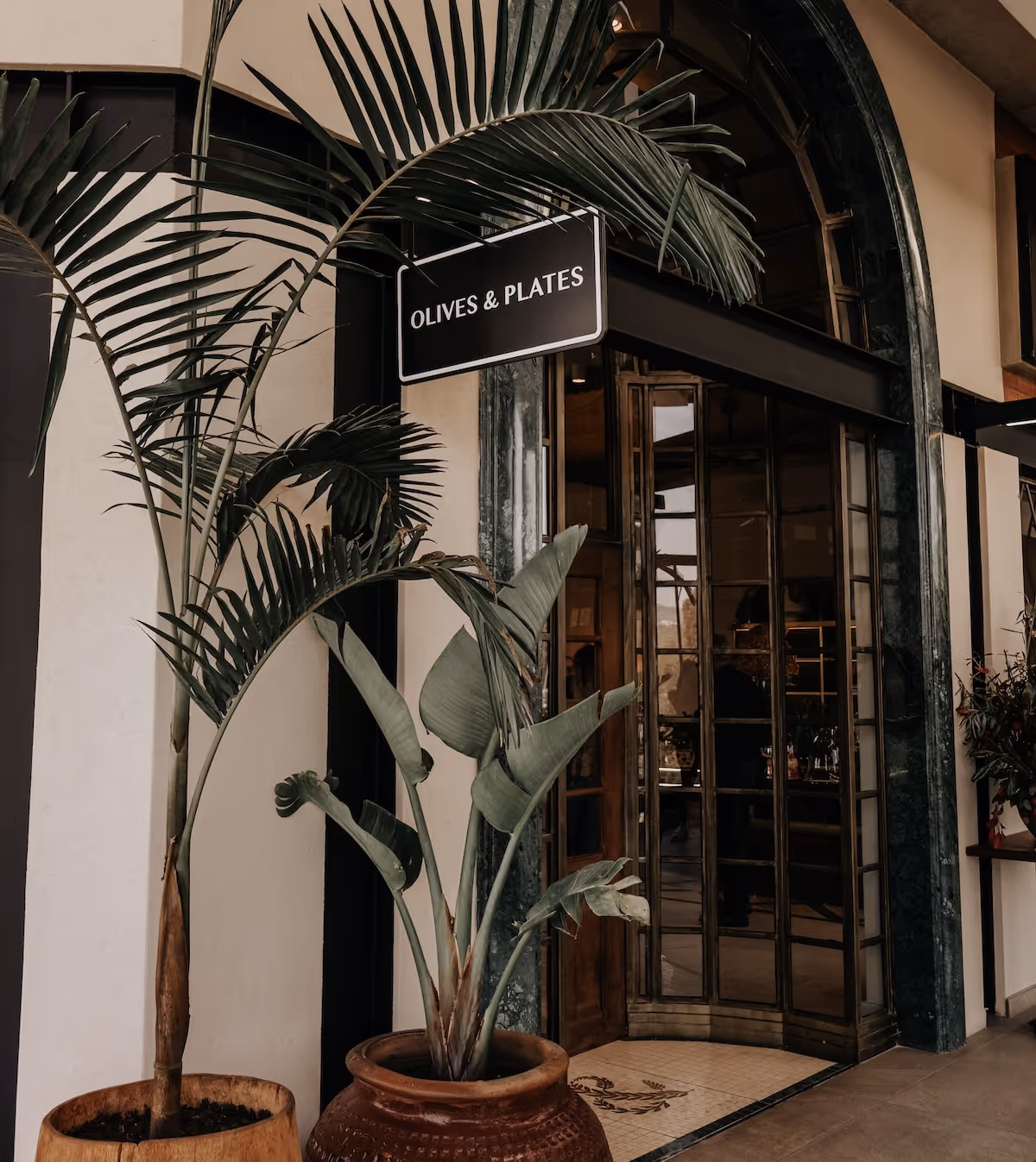 Picture of Olives and Plates sign outside their restaurant doors 