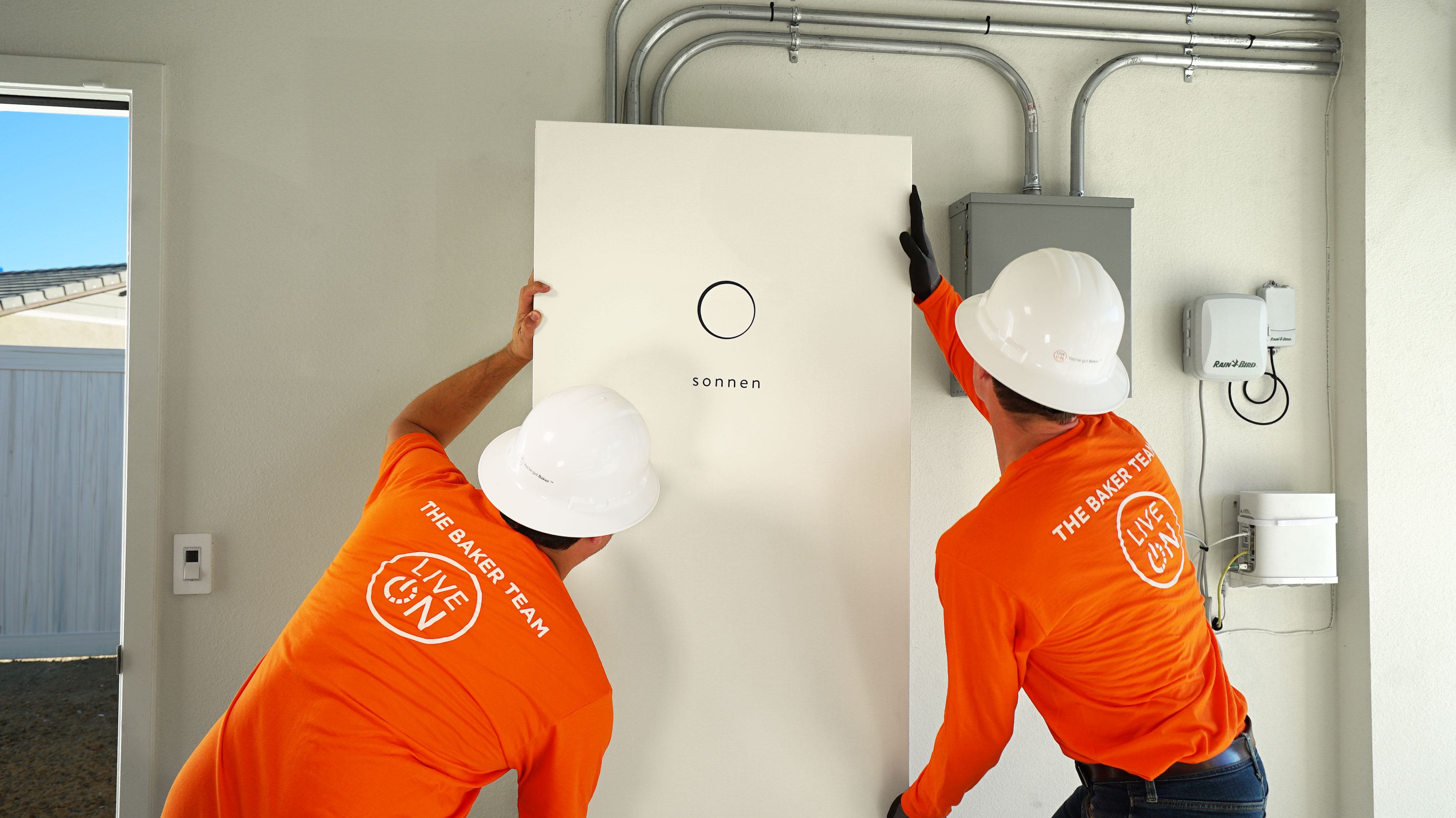 two workers install solar panels