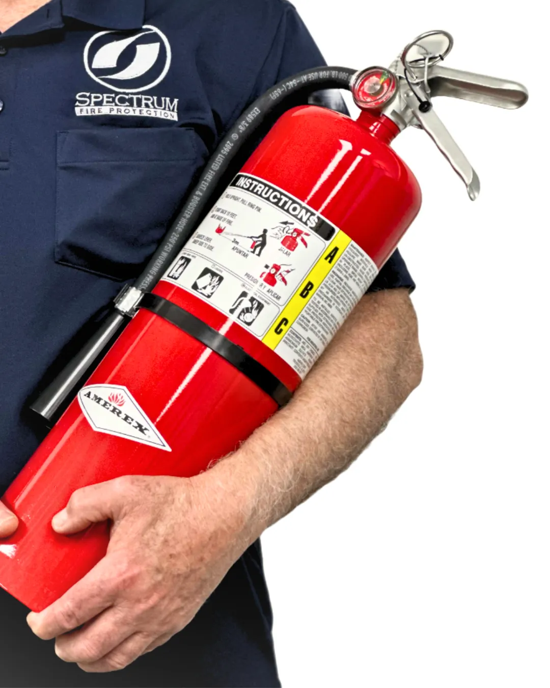 Person in navy shirt holding a red Amerex fire extinguisher with instruction label.