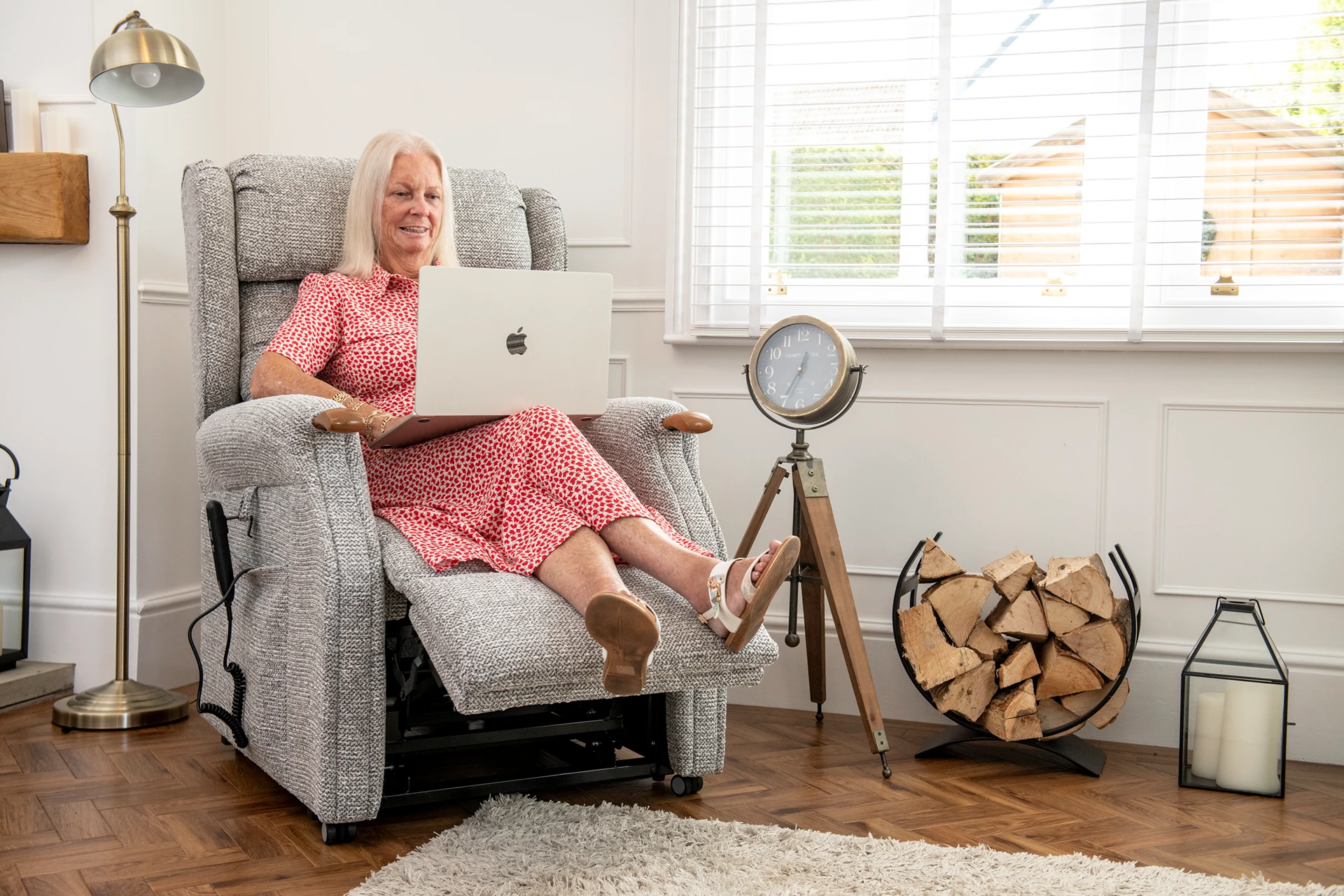 Woman on laptop sat in riser recliner