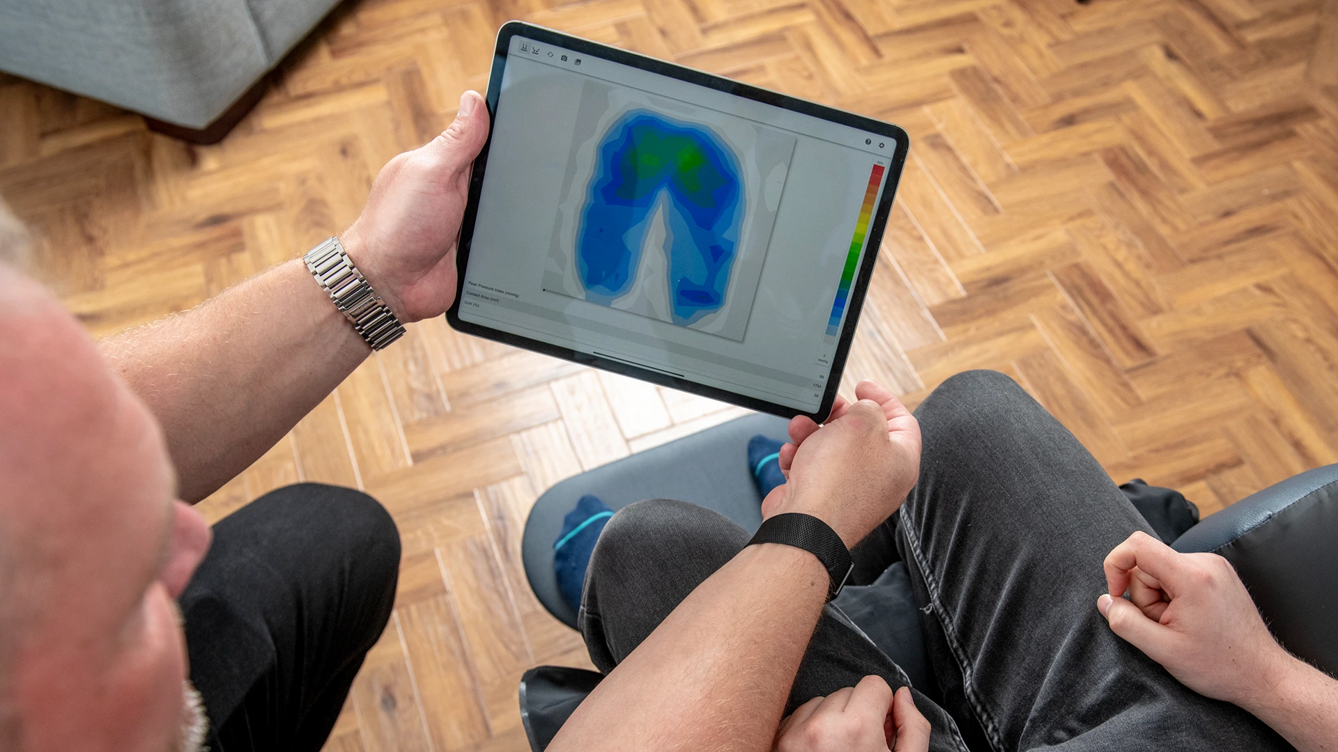 seating specialist showing pressure mapping tool to client